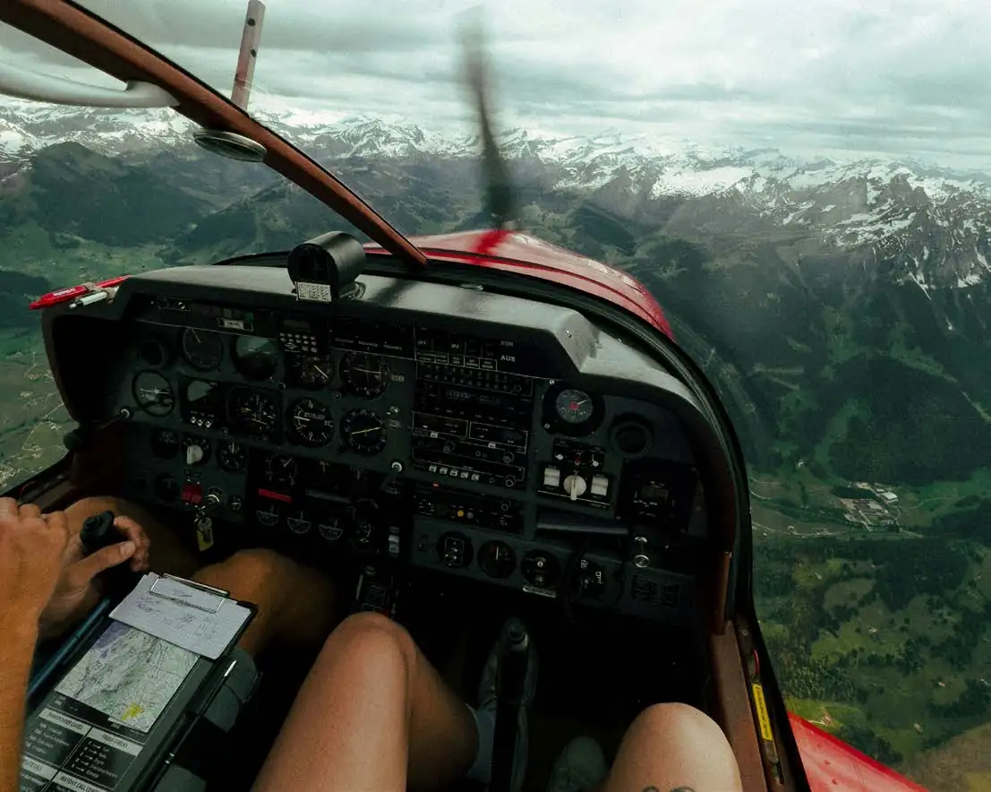 View from the left seat of a training airplane over the mountains